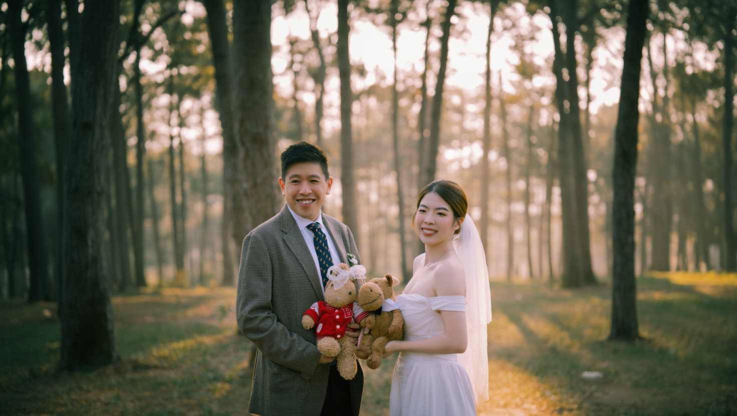 Shawn and An facing each other among the sunlit pines of Da Lat